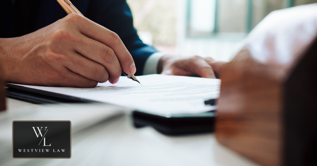 Employee reviewing wrongful termination settlement agreement with attorney