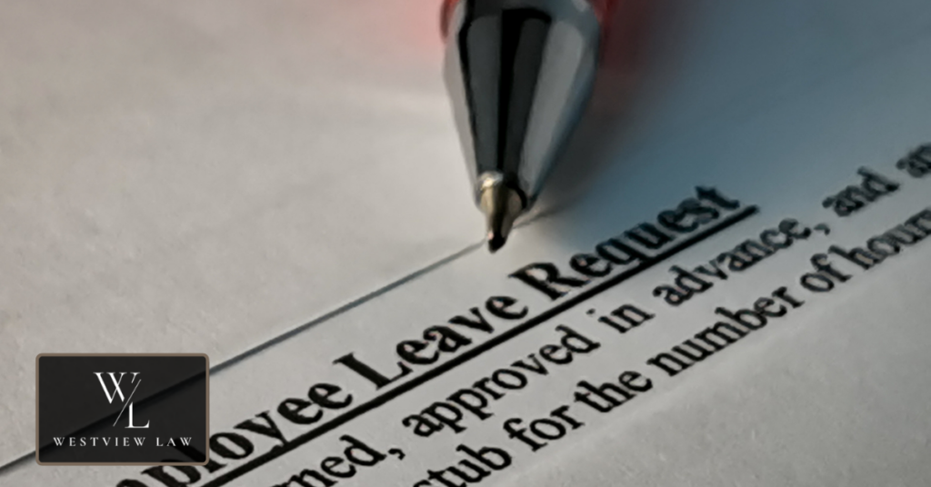 FMLA leave paperwork and employee rights documents on a desk