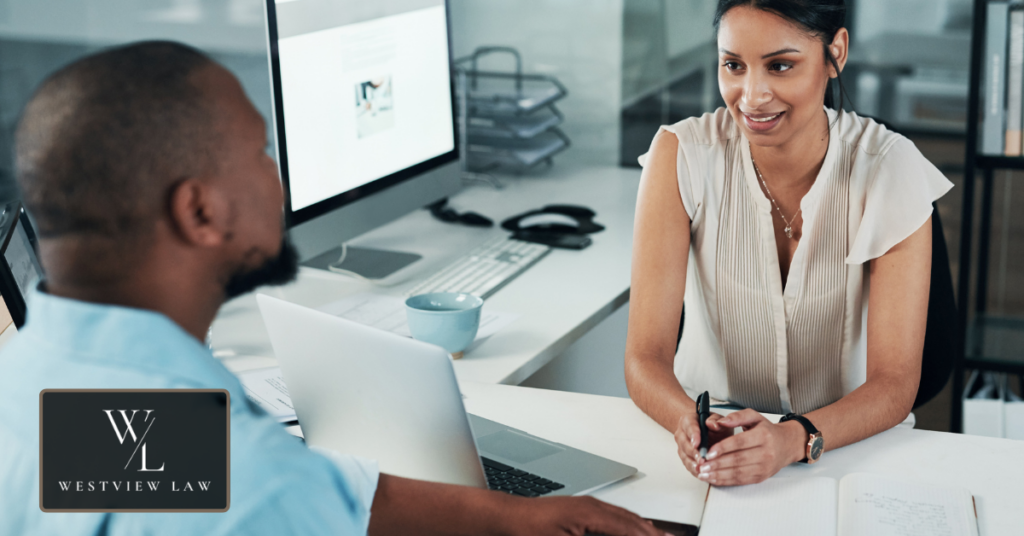 Employee reviewing workplace attendance and sick leave policies with management