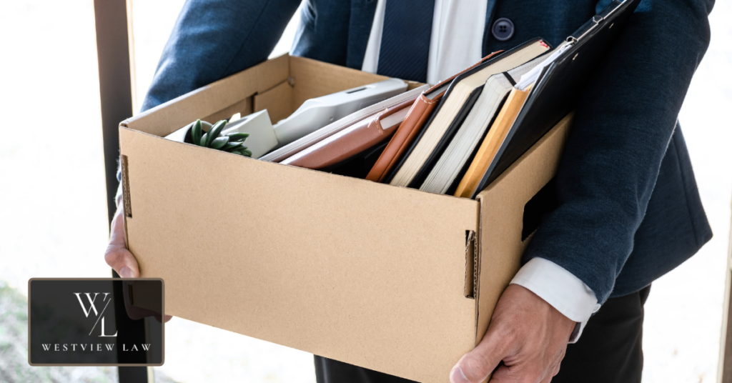 Employee reviewing documents after being terminated following multiple absences