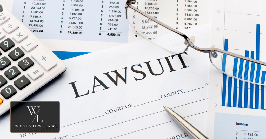Lawsuit document with calculator and financial records representing the calculation of employment lawsuit damages.