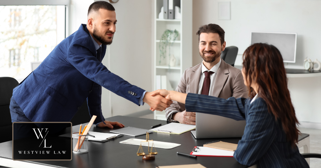 Employment attorney shaking hands with a client during a legal consultation.